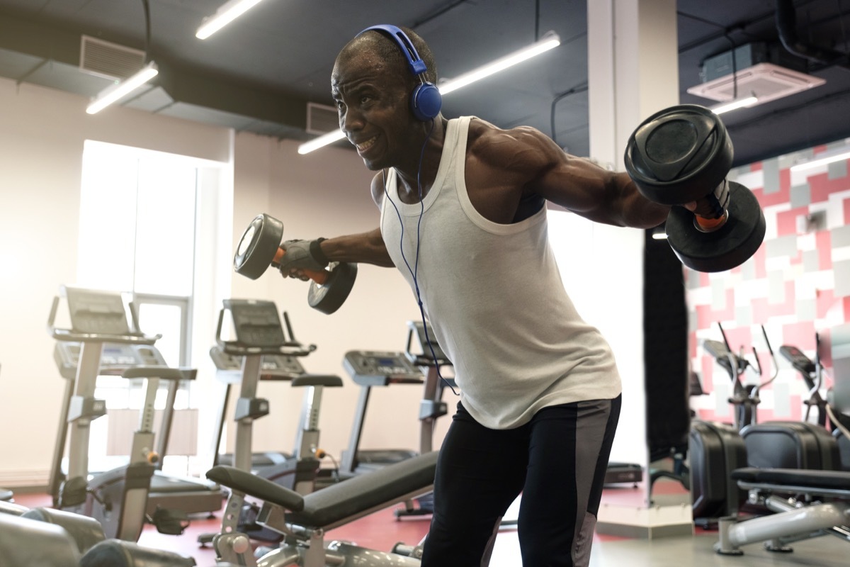 Man Listening to Music with Headphones at the Gym Healthy Man