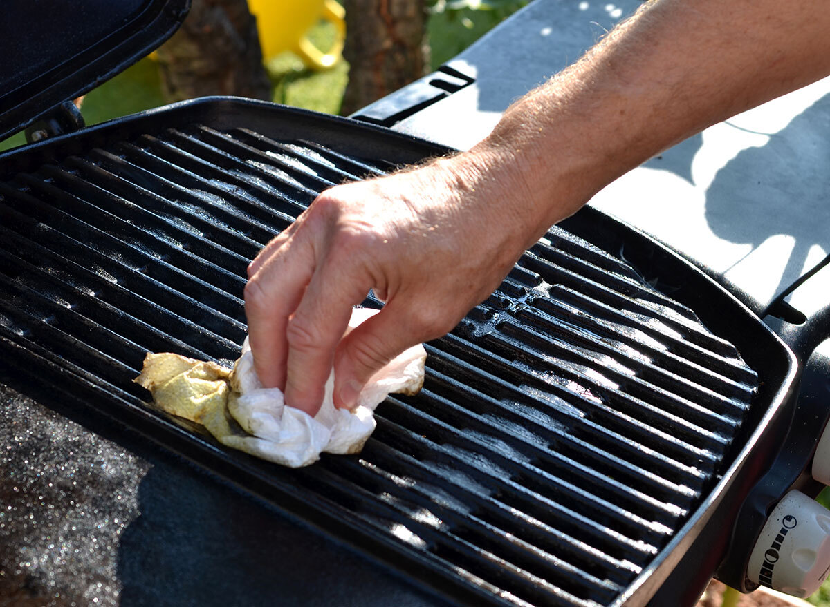 Person cleaning grill