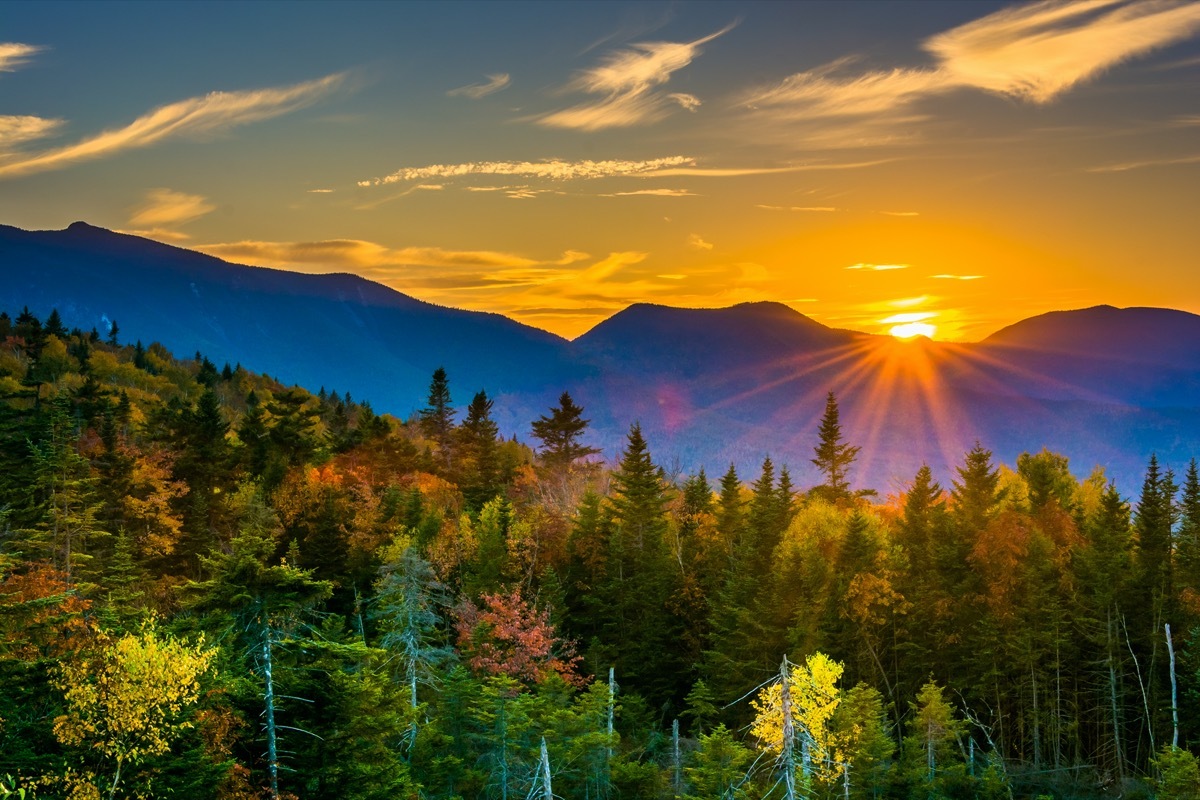 sunset over the peaks of a mountain in autumn