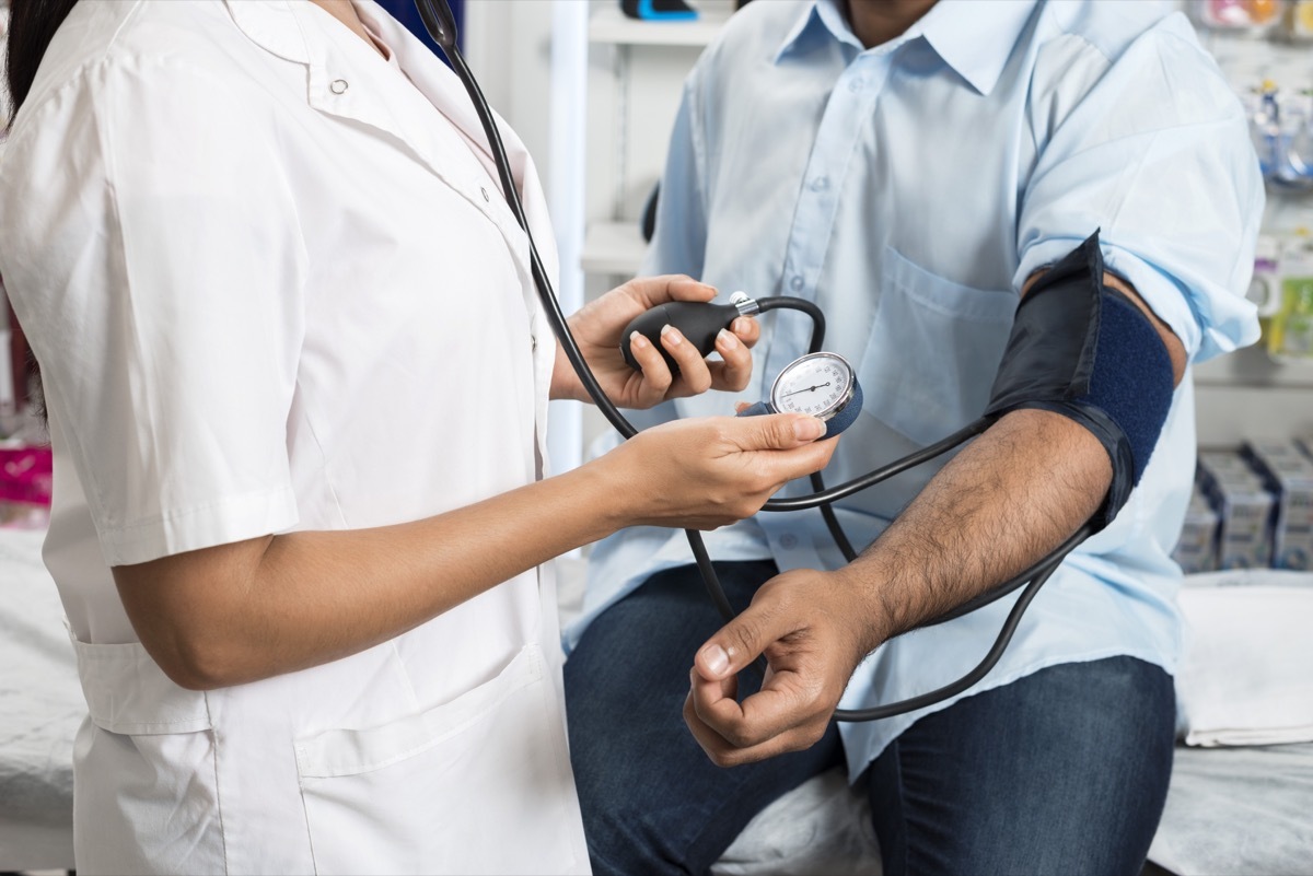 Doctor checking blood pressure