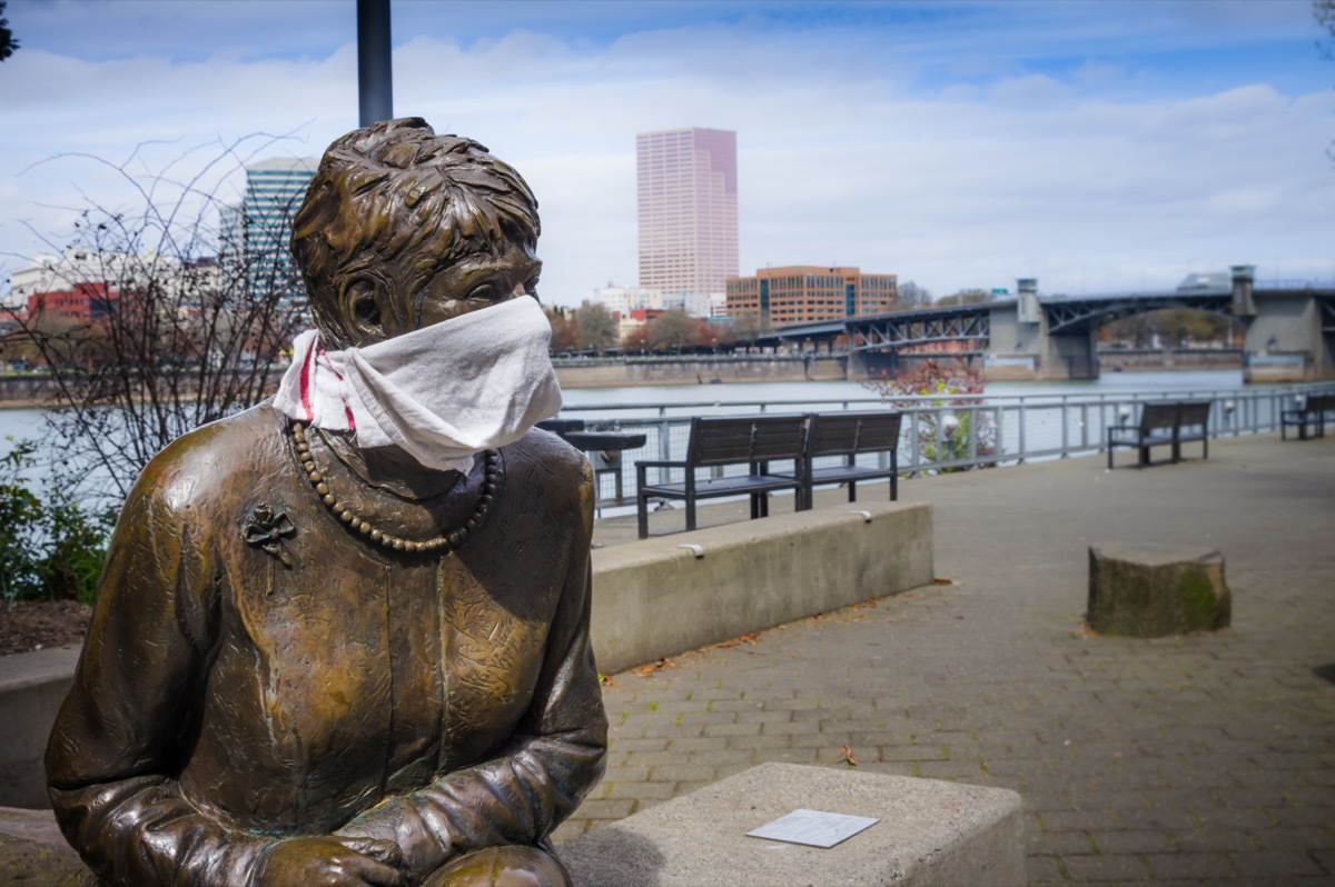 Statue of former mayor of Portland Oregon adorned with a scarf signifying a response to the covid-19 pandemic