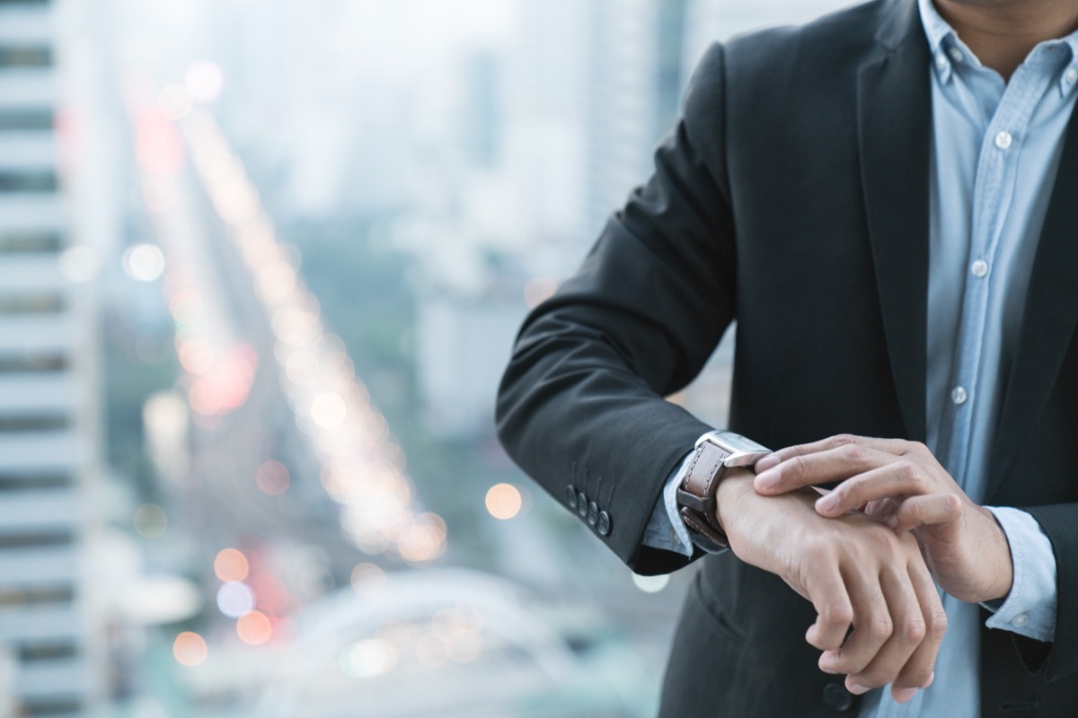 man looking at watch