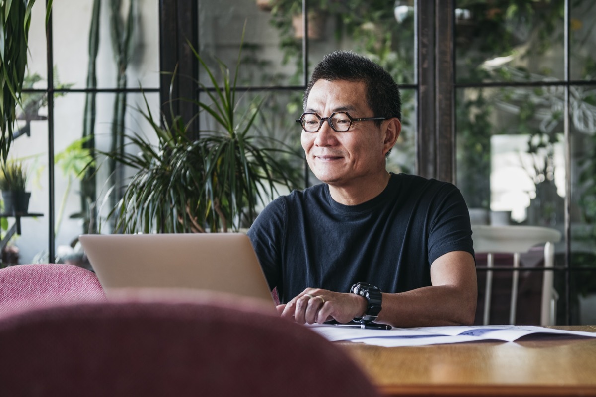 man looking at his finances on laptop