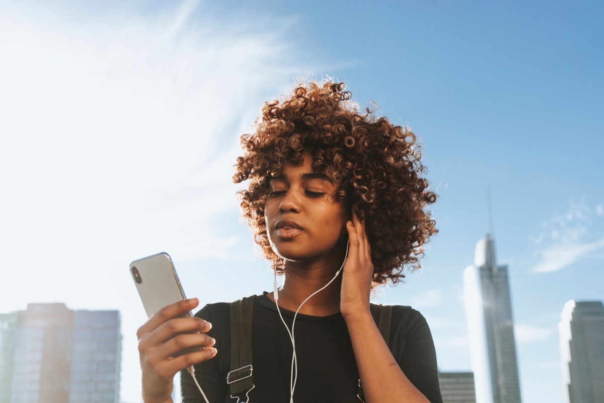 girl pressing play on her music