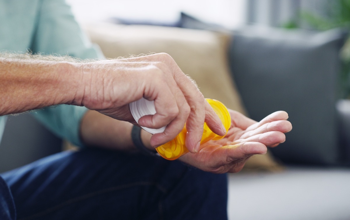 Shot of an unrecognisable senior man taking medication at home