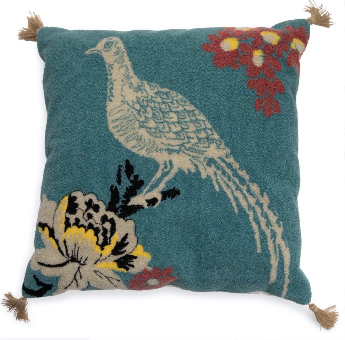 green pillow with peacock and tassels on it