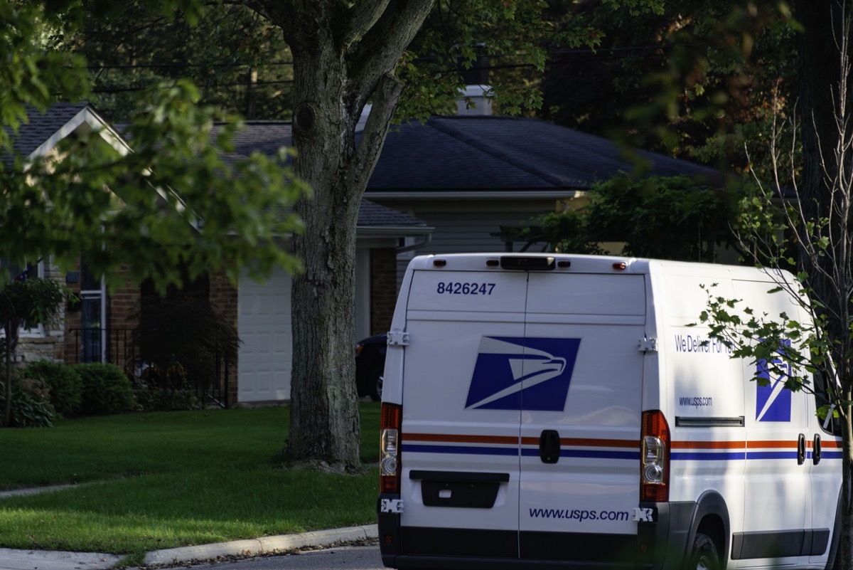 One of the newer Sprinter model USPS mail delivery trucks on a residential street in Rochester, Michigan.