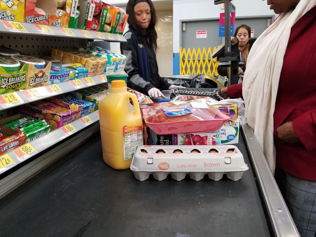 woman buying groceries at walmart checkout