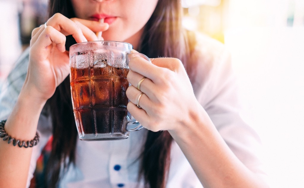 Woman drinking soda, words with different meanings