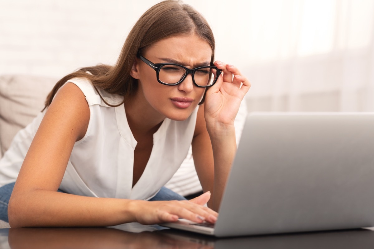 Woman squinting at computer screen