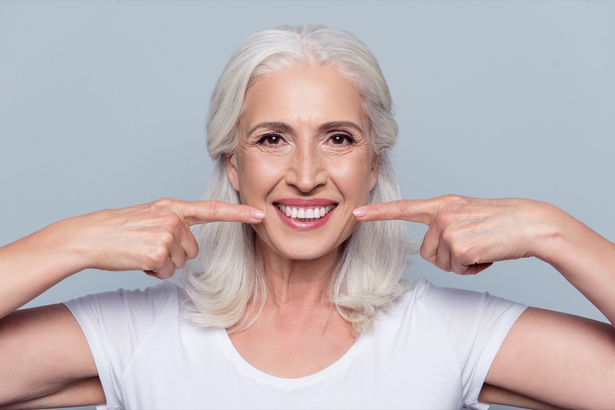 older woman giving a fake smile