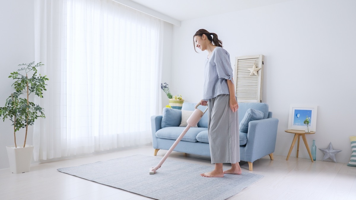 Young woman cleaning the room