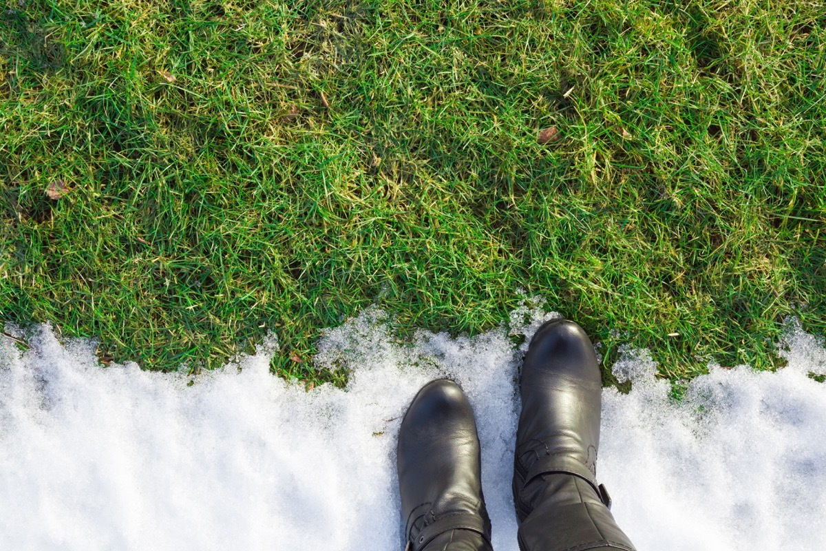 woman standing with boots on in a snow filled yard