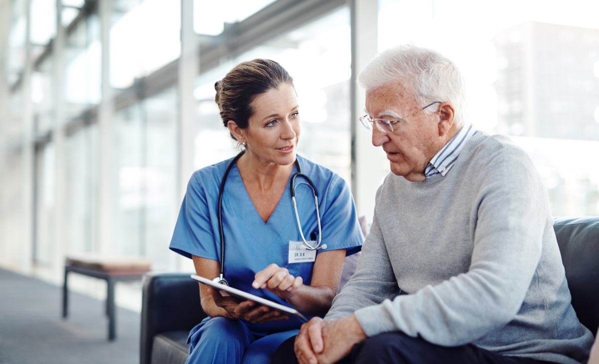 female nurse talking to a patient in the lobby