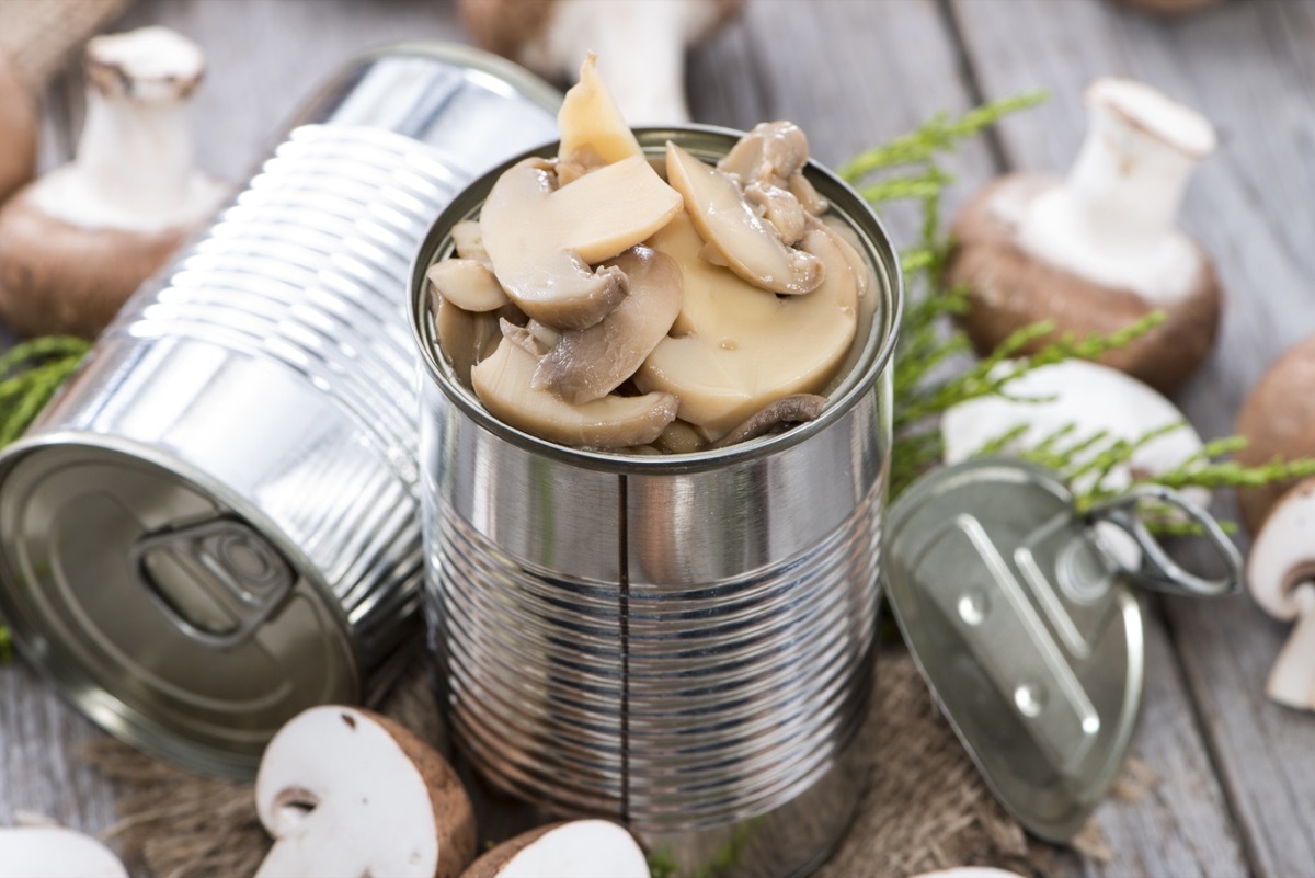 Portion of Canned Mushrooms on wooden background