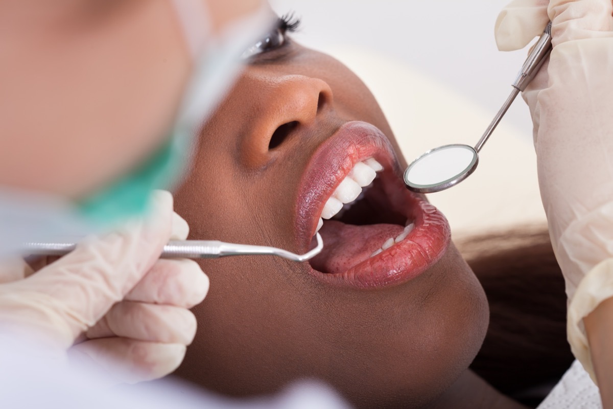 female patient being examined by dentist