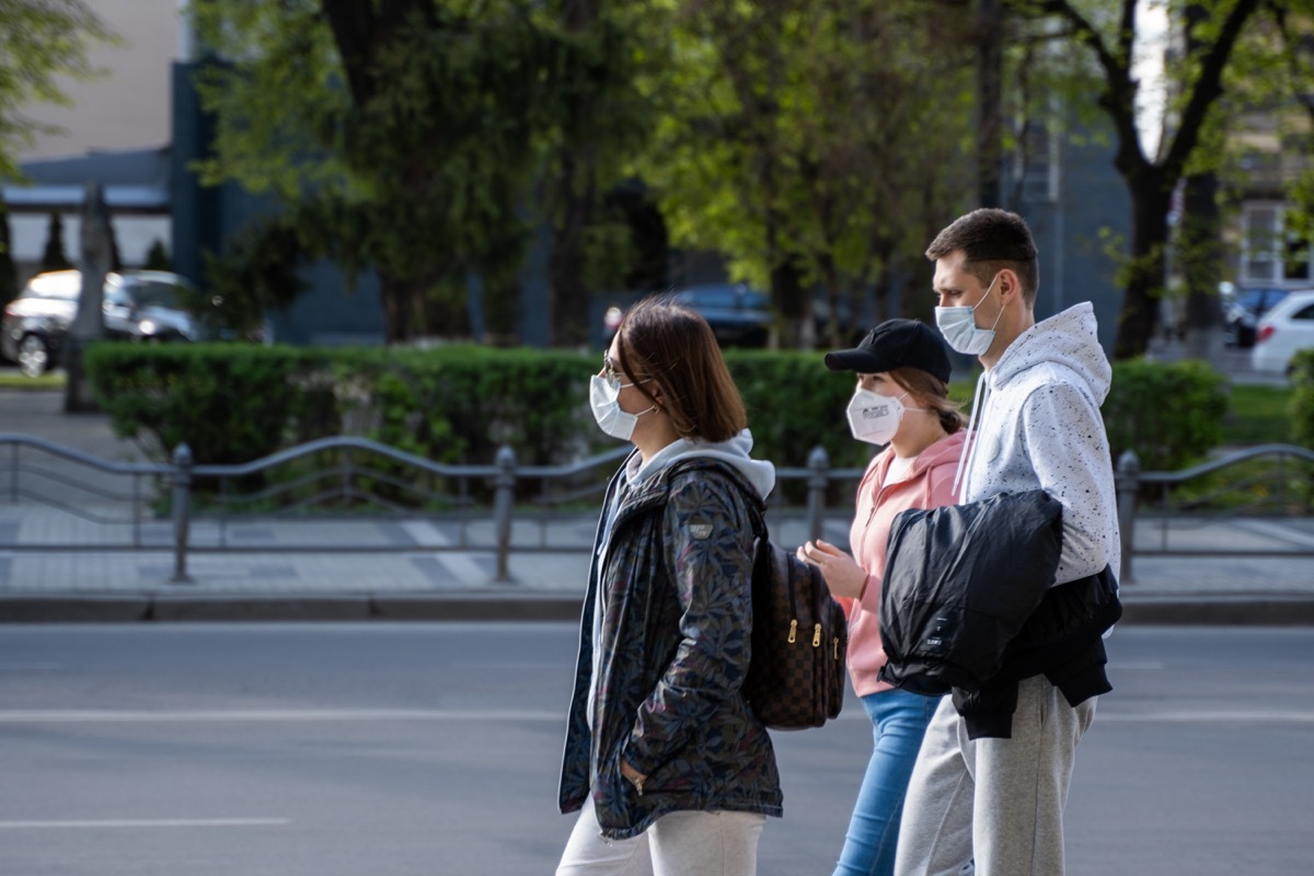 People walking wearing masks