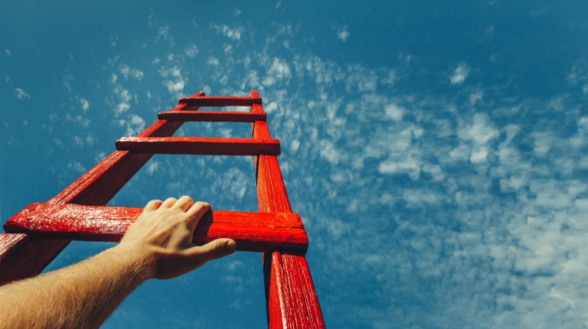 person climbing a red latter symbolizing success