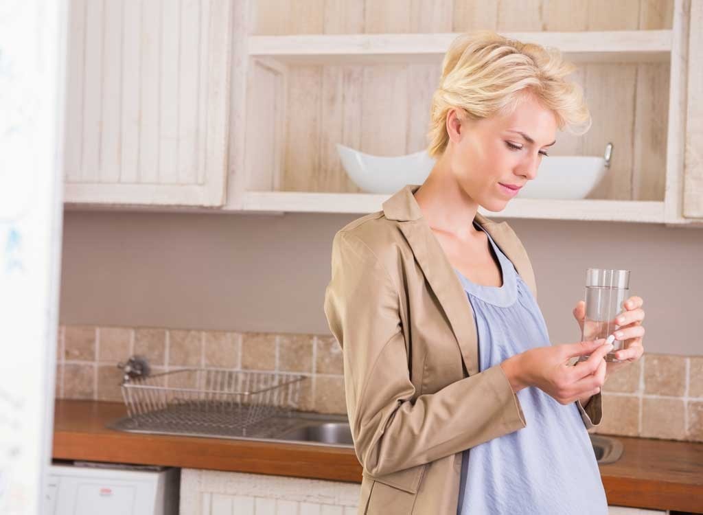 Pregnant woman holding glass of water