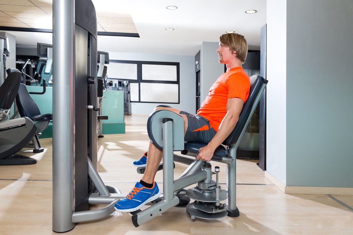 Man at the gym using a hip abduction machine