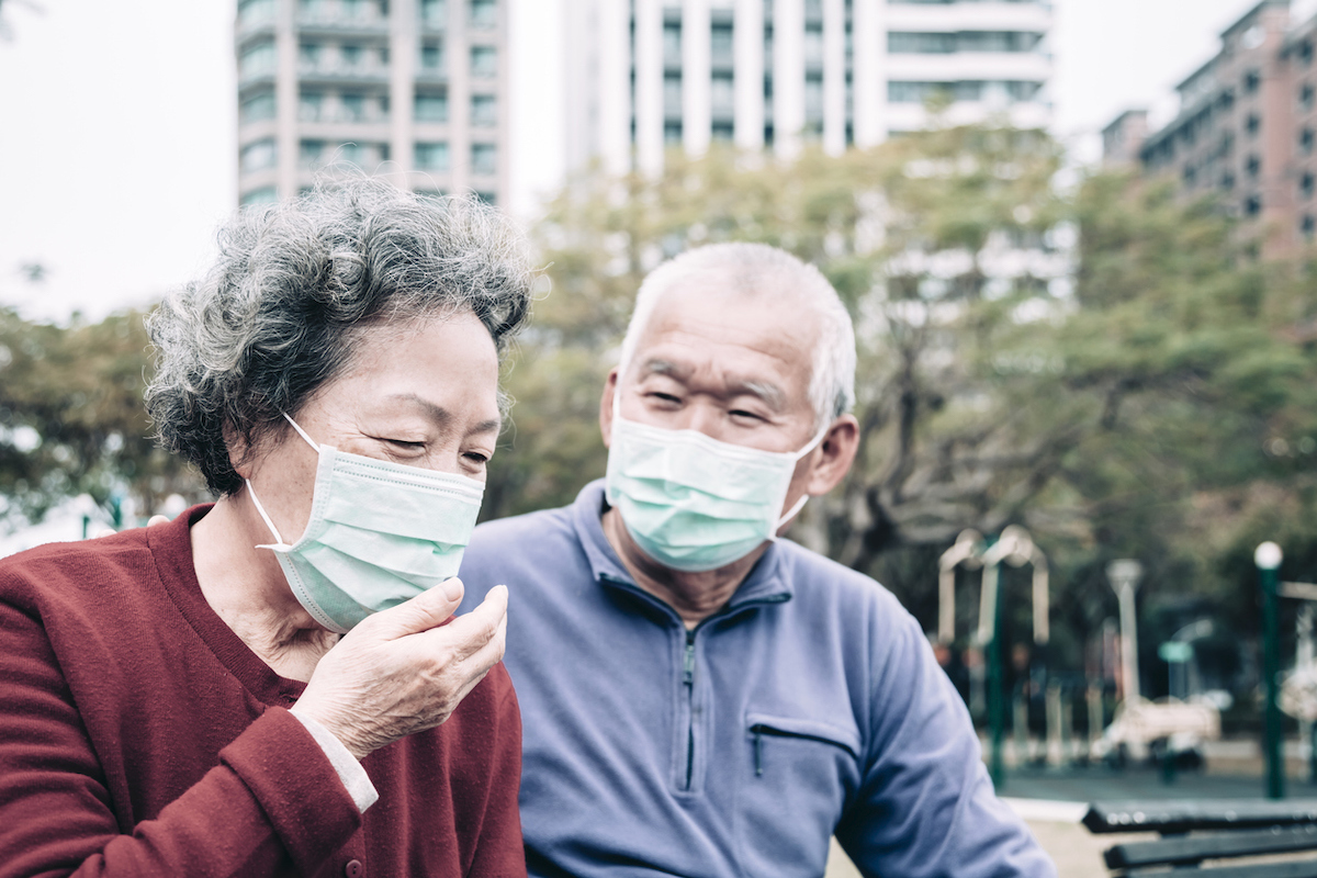 sick senior couple wear with protective face mask