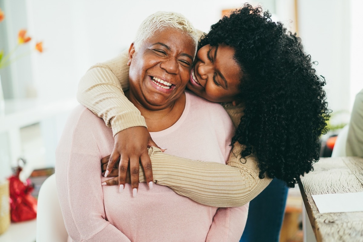 granddaughter hugging her grandmother