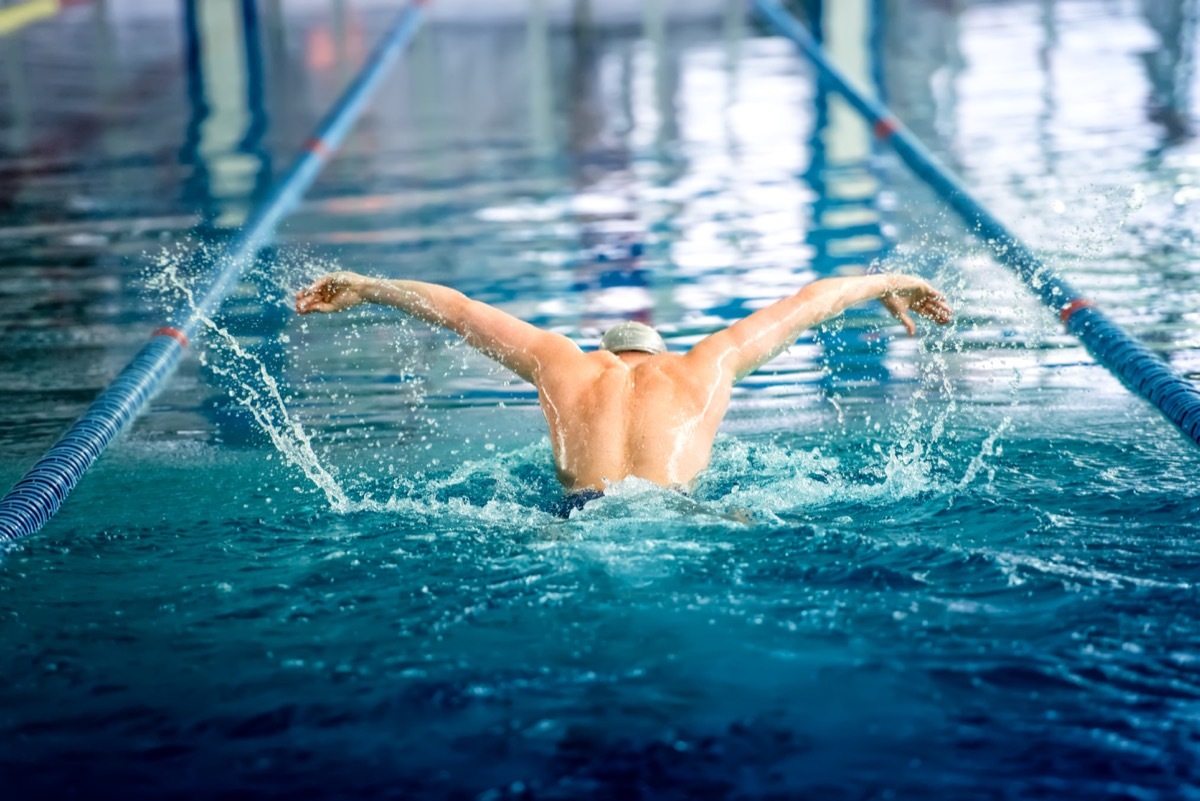 a man swimming in a lap pool