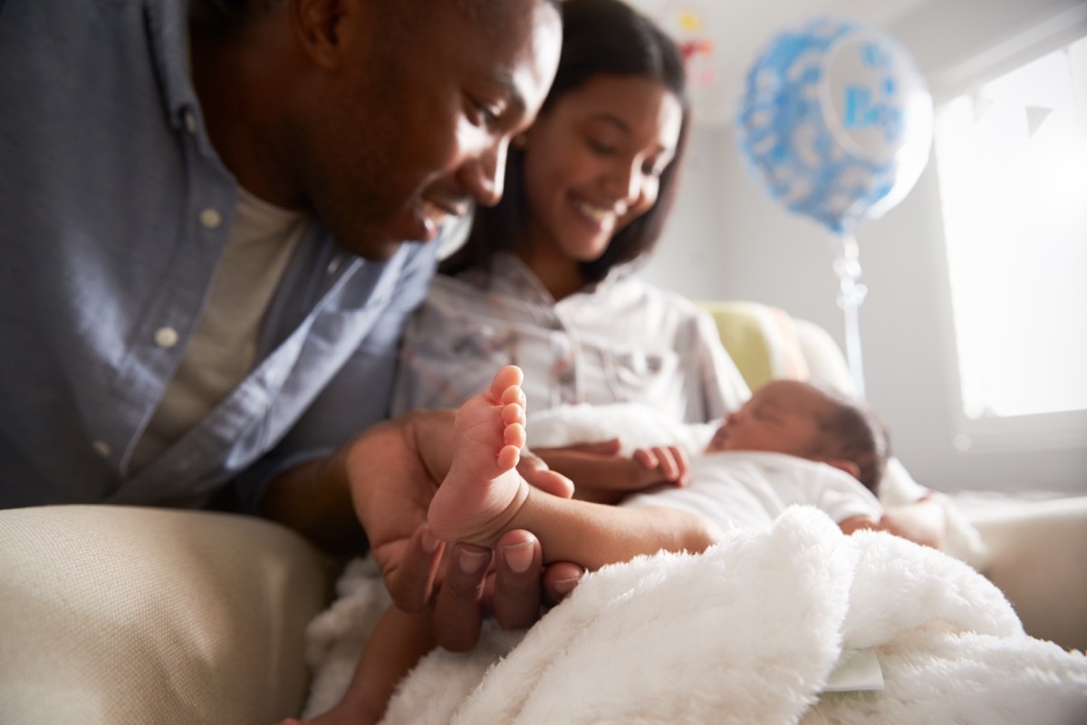 two parents smiling at a newborn child husband mistakes