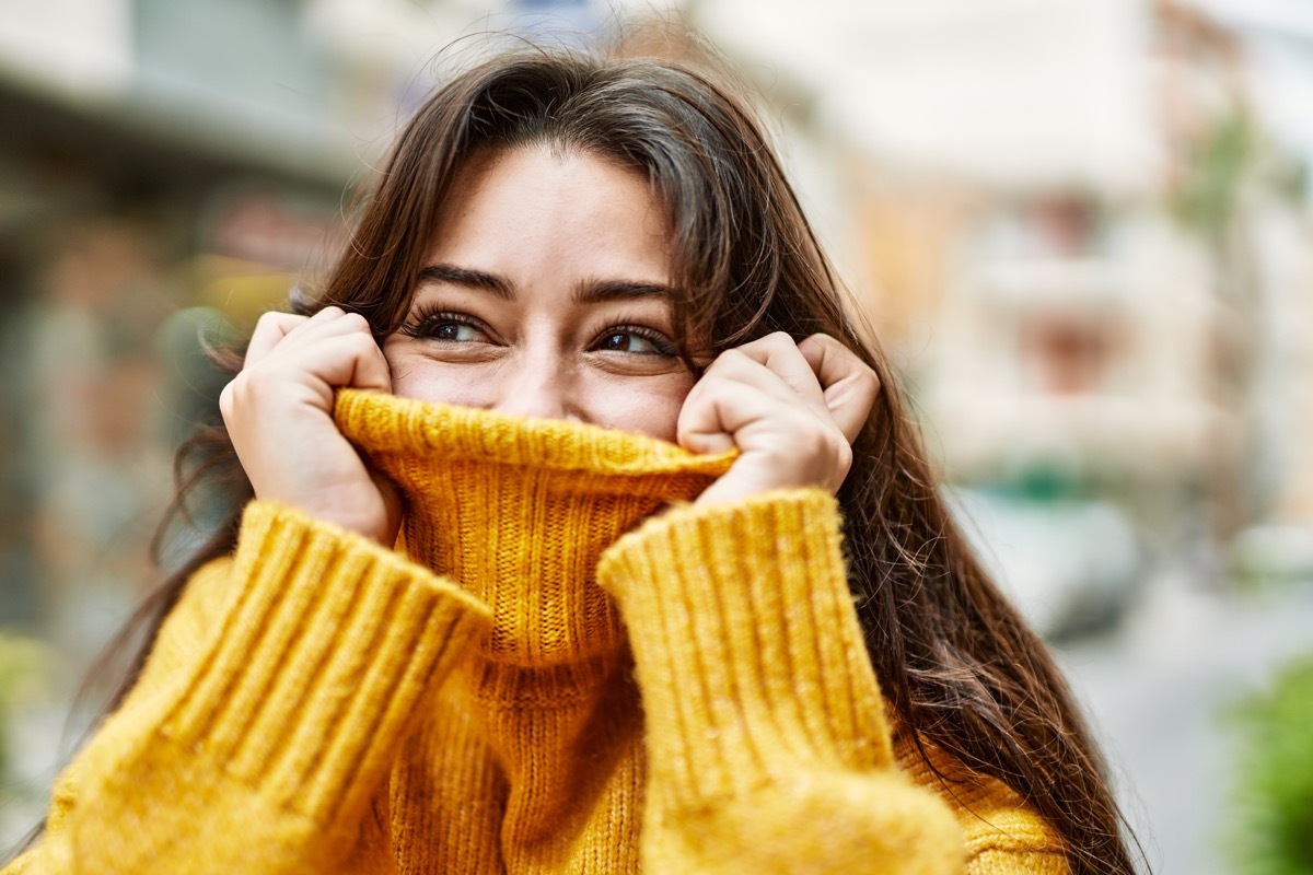 Woman wearing a bright yellow turtleneck.