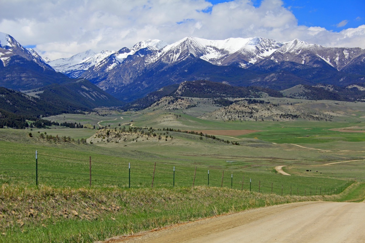 the road from big timber town leading to the crazy mountain range in montana