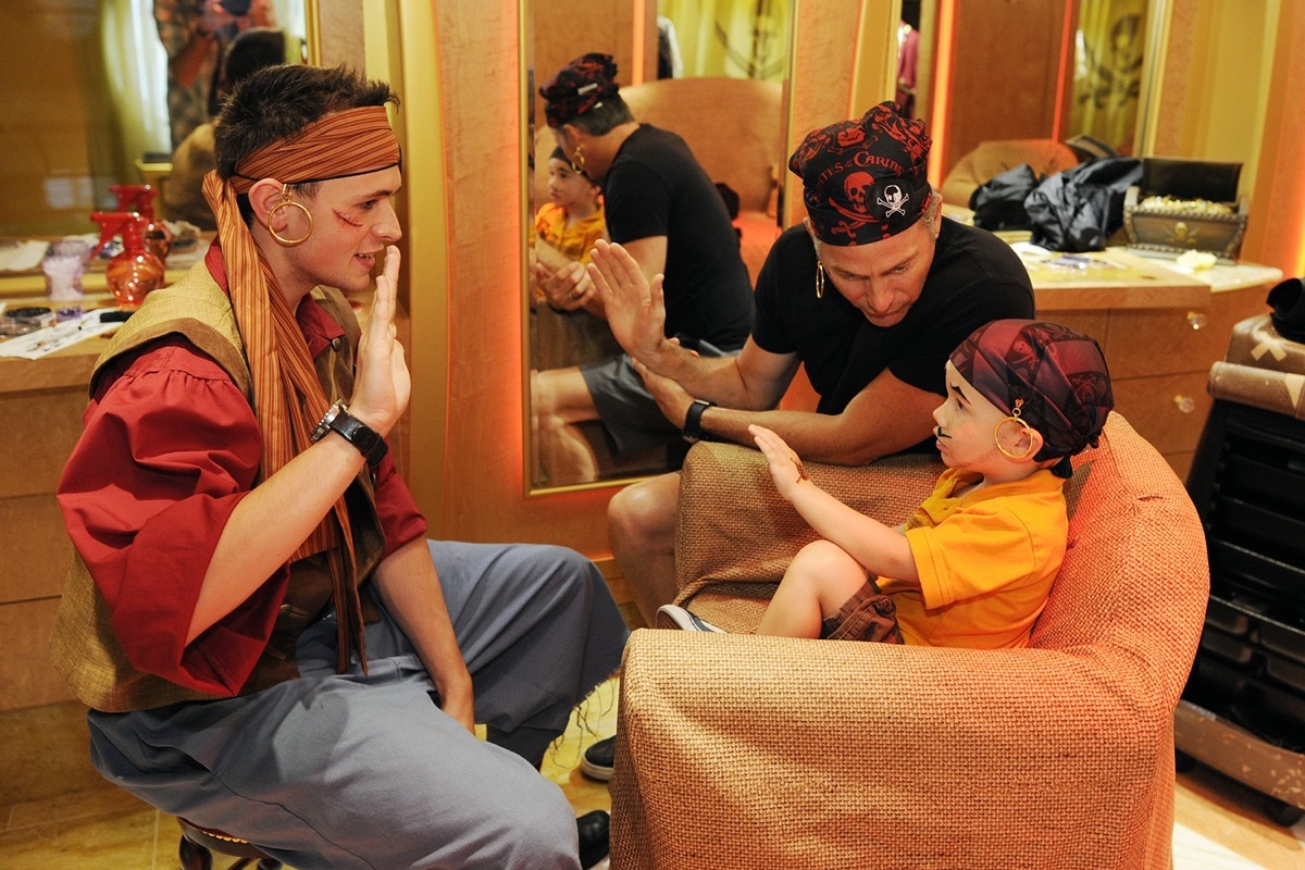 2 men and a boy preparing the costumes for pirate night