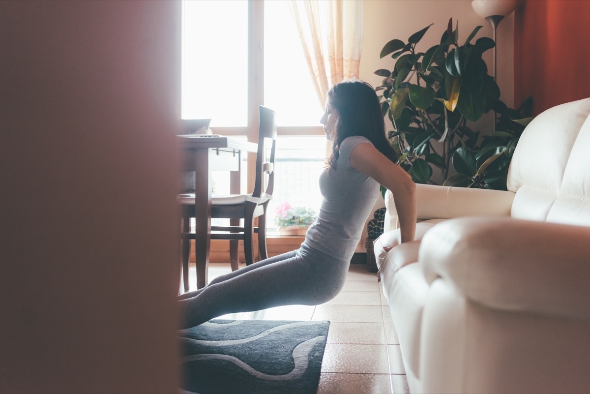 Woman exercising while watching TV