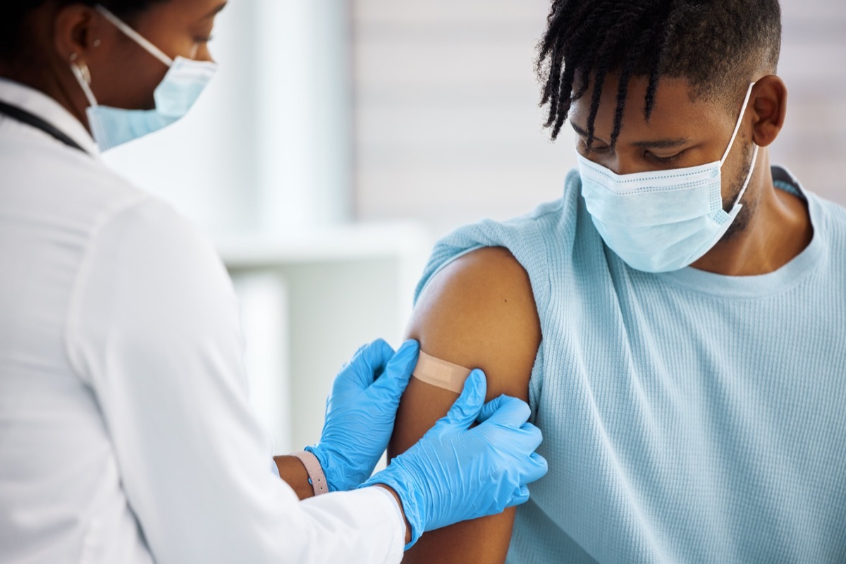 Shot of a doctor applying a plaster to her patients arm