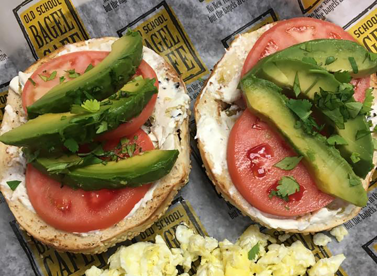 two bagel halves with tomato and avocado