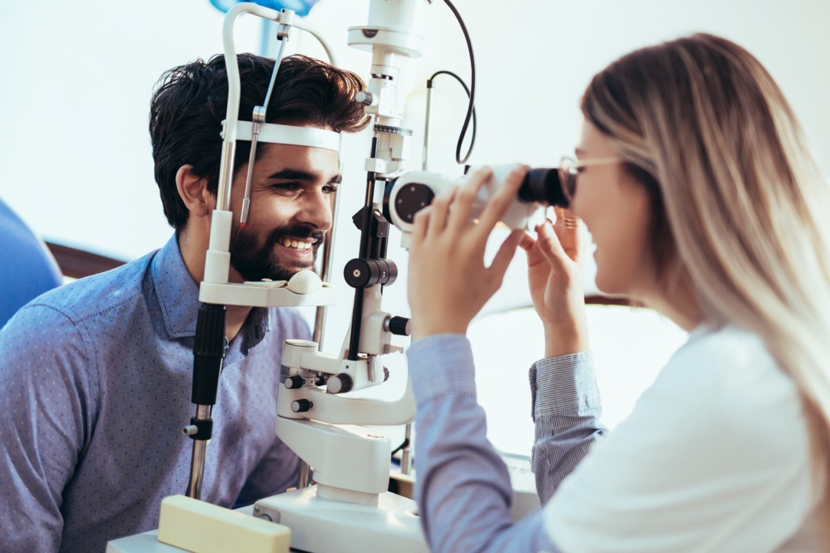 Optometrist checking patient eyesight and vision correction