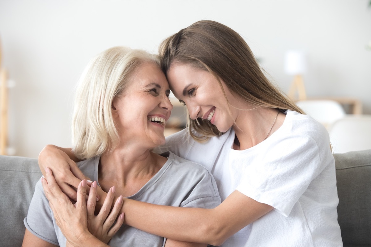 Daughter embracing mother smiling