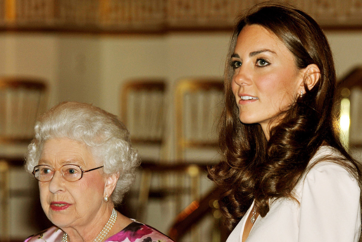 Queen Elizabeth ll and Catherine, Duchess of Cambridge view a display of items for the Duke and Duchess of Cambridge's wedding on display at Buckingham Palace for the annual summer opening on July 22, 2011 in London, England. 