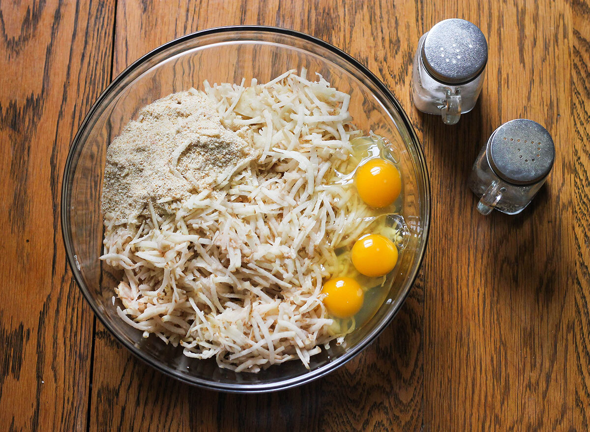 Mixing together ingredients to make homemade potato latkes