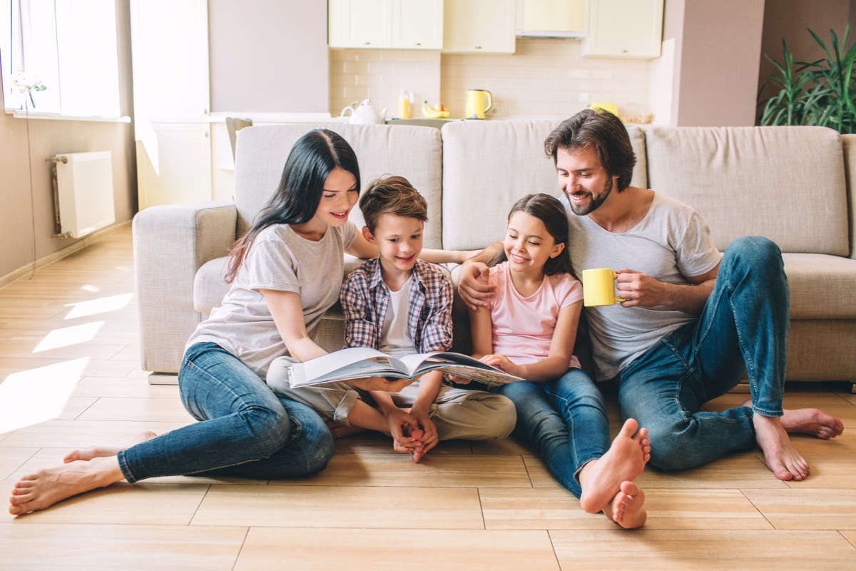 Family sitting on floor reading