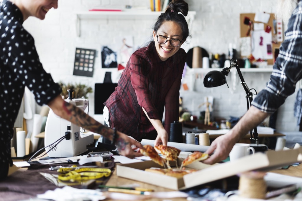 people having pizza in the office