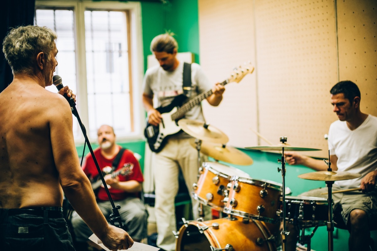 men in their 40s playing in a garage band