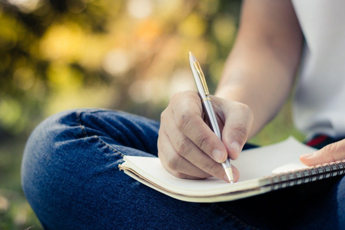 Woman writing in notebook