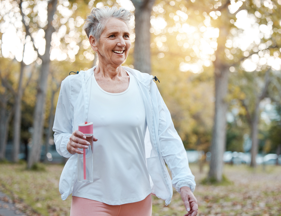 Older Woman Walking Outside in Light Clothing