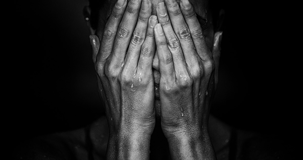 woman crying on black background