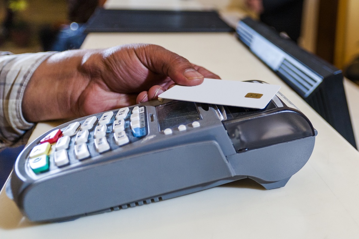 Close up of a hand using a credit card to pay