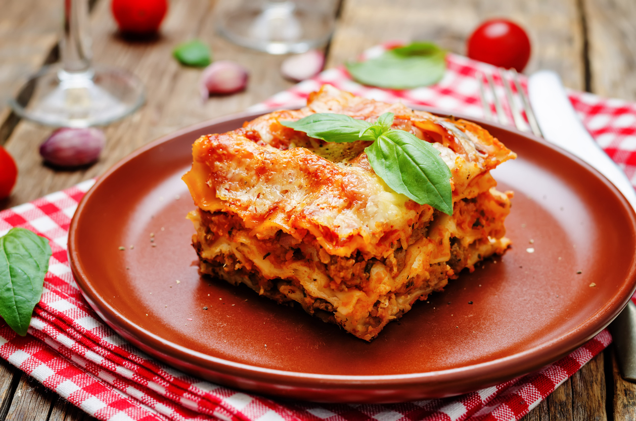 Meat lasagna on a dark wood. background. toning. selective focus