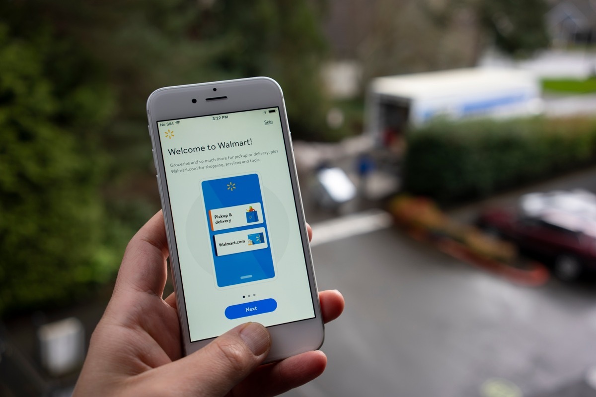 A man launches the Walmart mobile app from his iPhone. The app is a convenient way to check off your shopping and your groceries list.