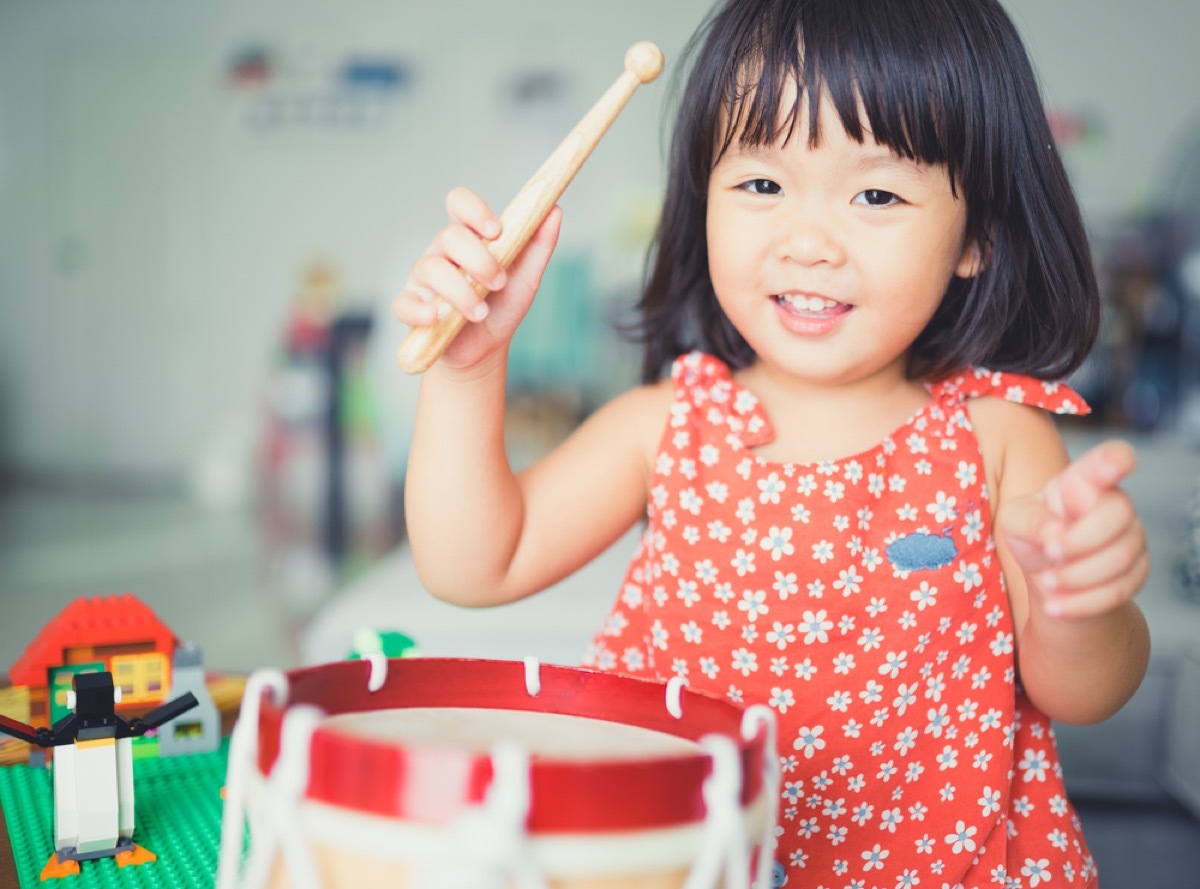 little kid playing toy drum, empty nester