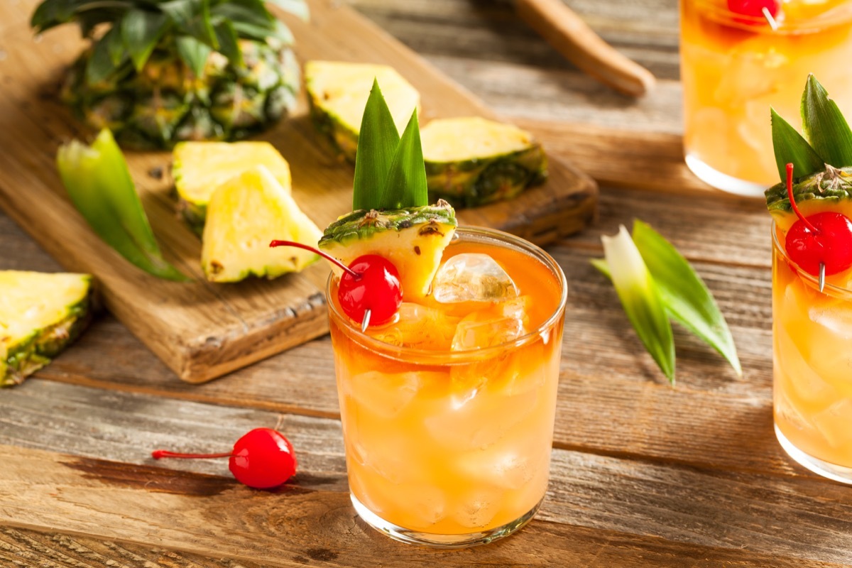 mai tai cocktail with cherry, in a glass on wooden table