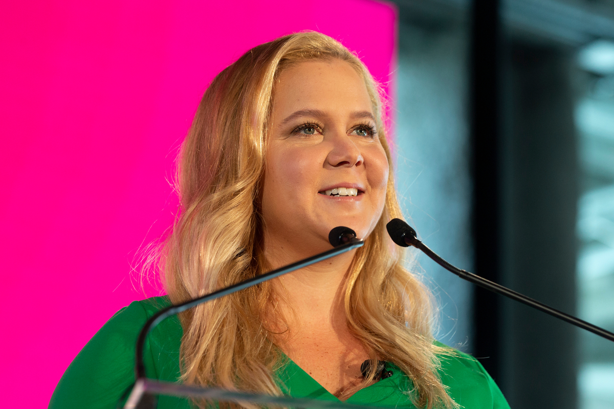 amy schumer speaking at a podim